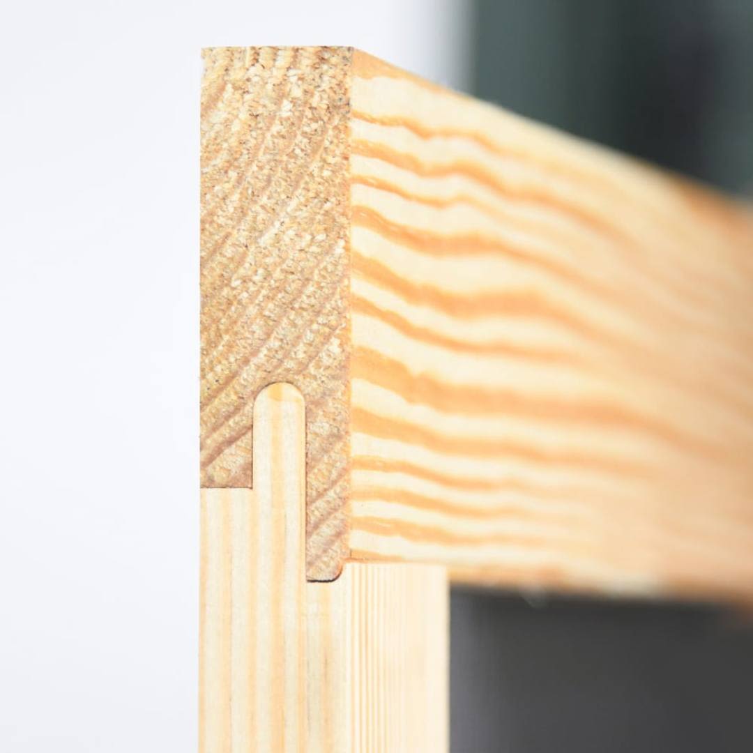 Close-up of mortise and tenon joinery on natural wood frame in lumber and exterior doors collection for home improvement
