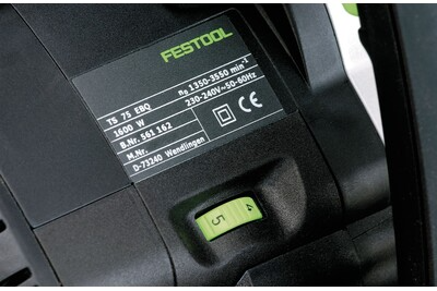 Close-up of the black and green electric plungecut saw with model and safety labels in power tools collection