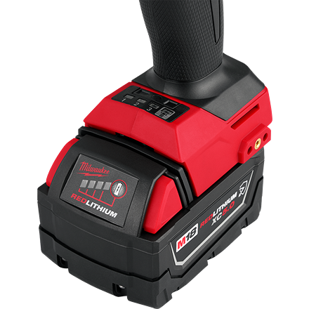 Close-up of a red and black high capacity lithium battery pack on a cordless power tool handle for home improvement use