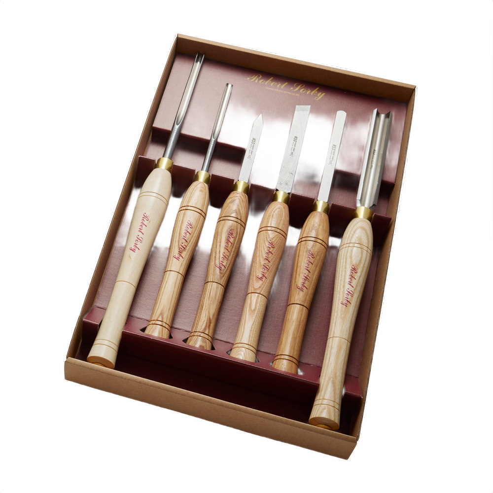 Six woodturning hand tools with polished wooden handles and steel blades in a Robert Sorby woodturning tool set box