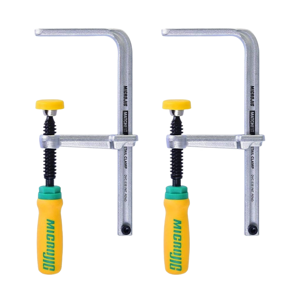Pair of metal dovetail clamps with yellow and green ergonomic handles for woodworking and home improvement tasks