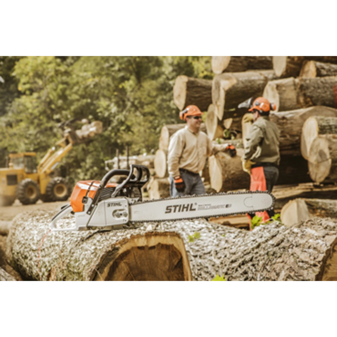 Orange and white Stihl chainsaw with 28-inch guide bar resting on large tree log at a lumber site.