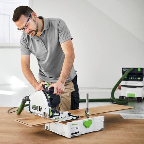 Man using Festool plunge saw with guide rail and tabletop systainer for woodworking and workshop organization