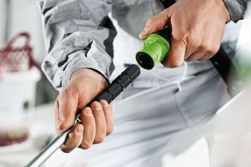 Person attaching black hexagonal rod adapter to green ergonomic tool handle for power tool accessories collection