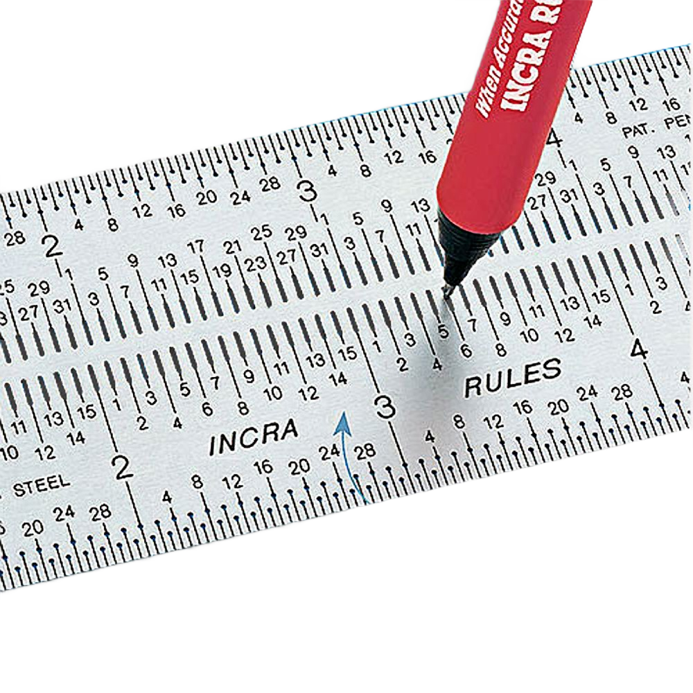 Close-up of steel marking rule with precise measurement markings and red pen for home improvement and tools use