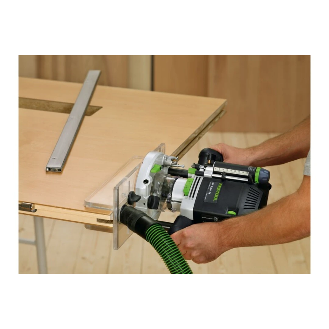 Hands operating a Festool router with a clear plexiglass routing template for woodworking tool accessory use