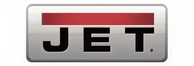 Rectangular metallic emblem with a horizontal red bar above bold black letters spelling 