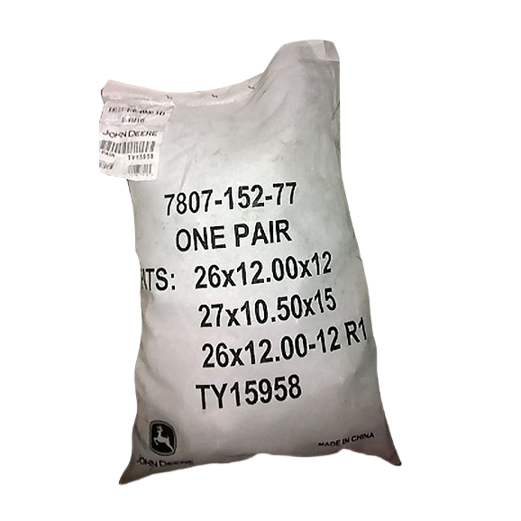 White protective bag containing a pair of tire chains designed for heavy-duty outdoor use with specified tire sizes