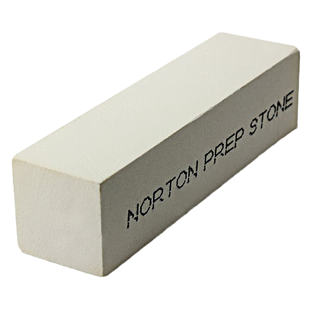 Rectangular white sharpening stone with black text, used for tool preparation and maintenance in home improvement.