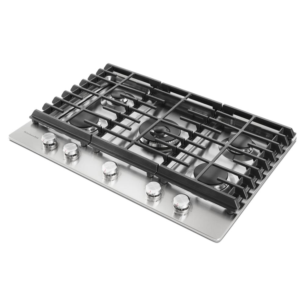 Stainless steel five-burner gas cooktop with black cast iron grates and control knobs for home improvement use