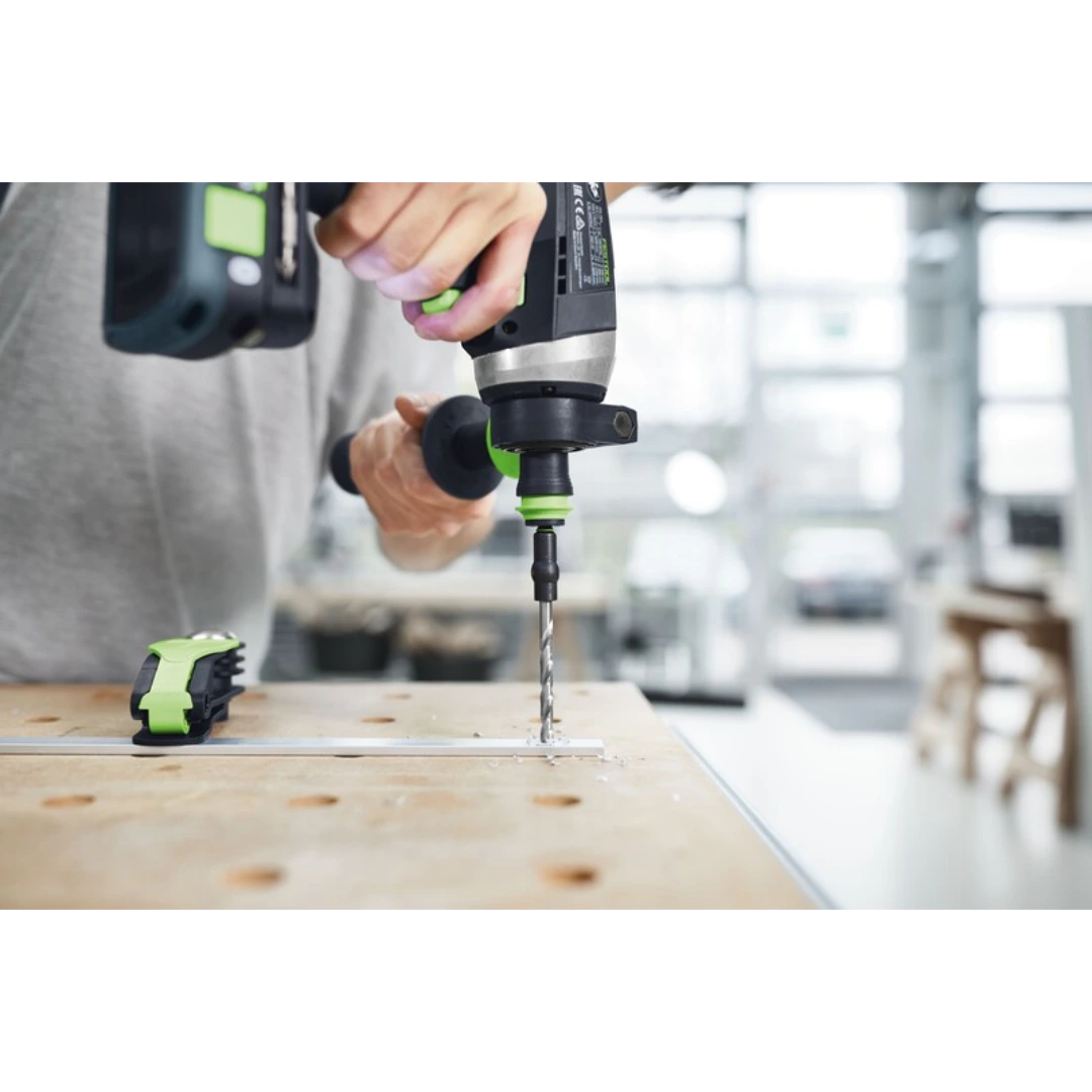 Person using cordless drill with centrotec HSS spiral bit drilling metal on workbench for home improvement tool accessory