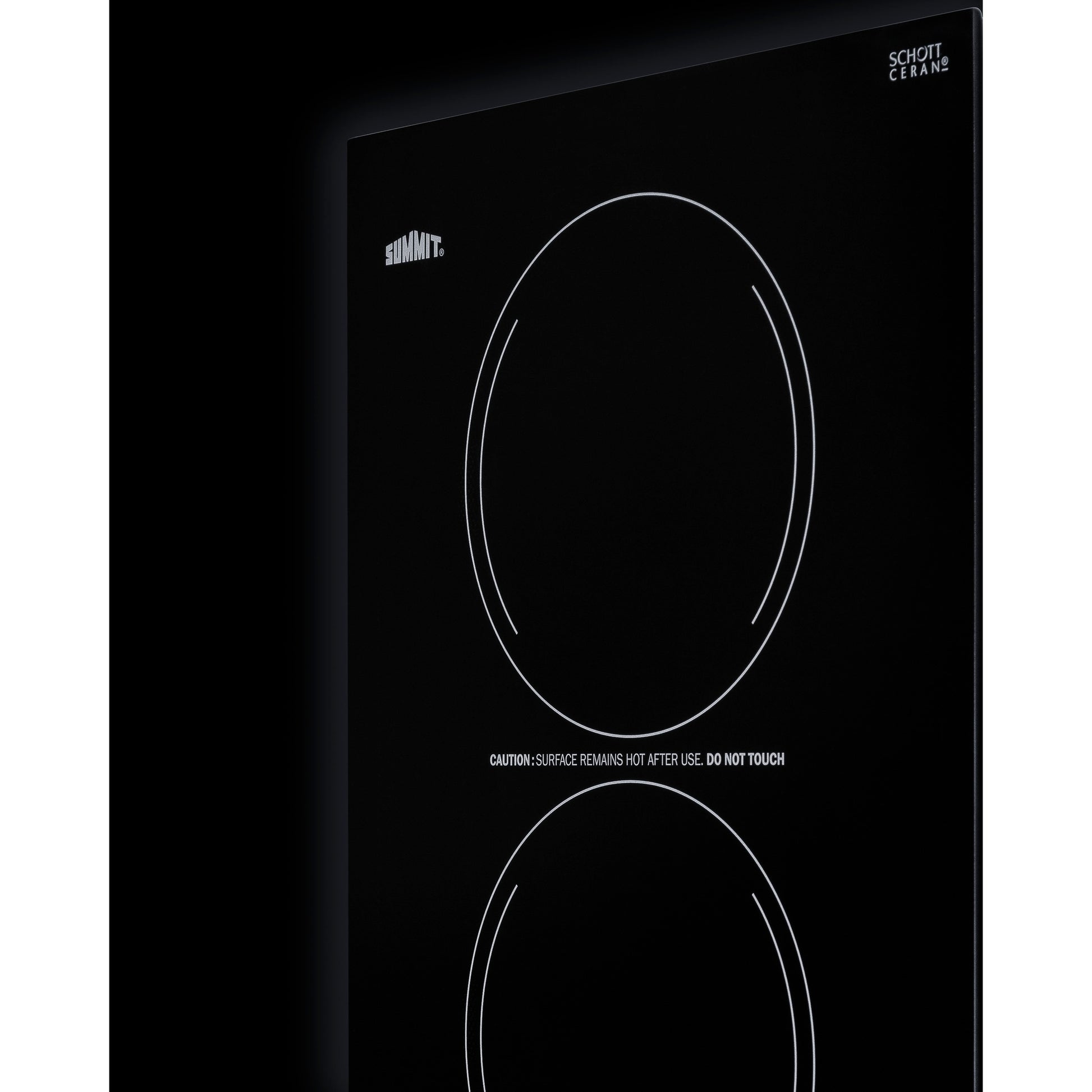 Black glass radiant cooktop with two circular burners and visible warning text for safe home improvement use