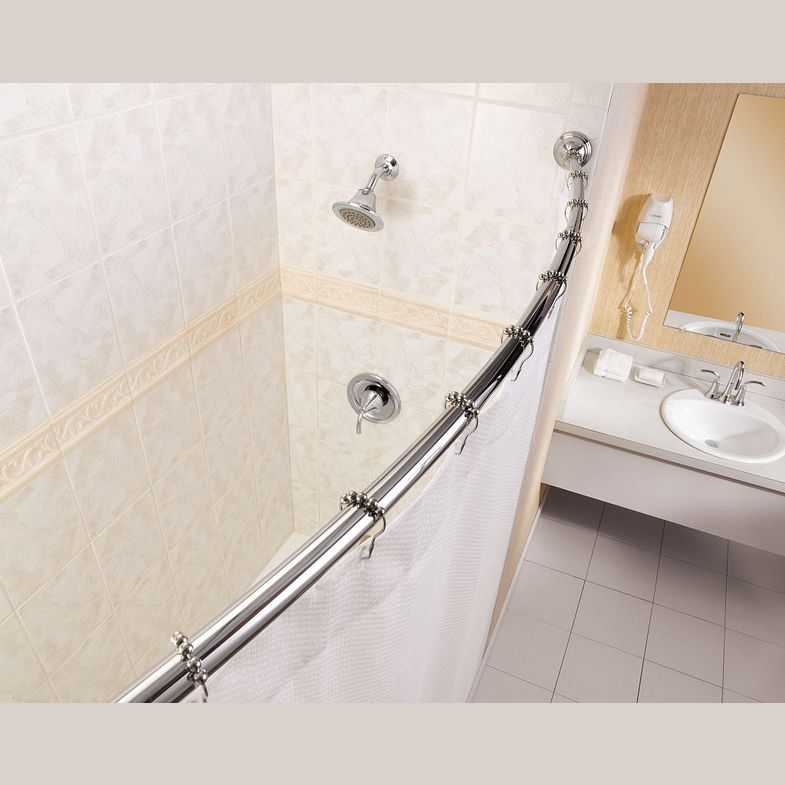 Shiny chrome adjustable curved shower rod with hooks installed in a bathroom for home improvement use