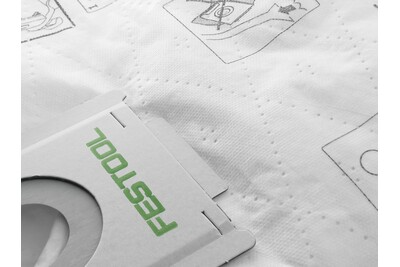 Close-up of white Festool branded dust extractor filter bag with printed usage instructions for woodworking tools and dust collection
