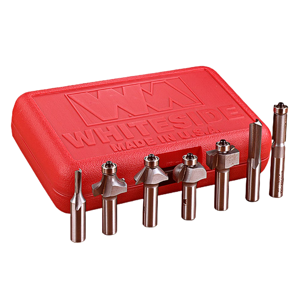 Set of seven 1/4 inch shank router bits displayed in front of a red Whiteside case for tool accessories and woodworking.