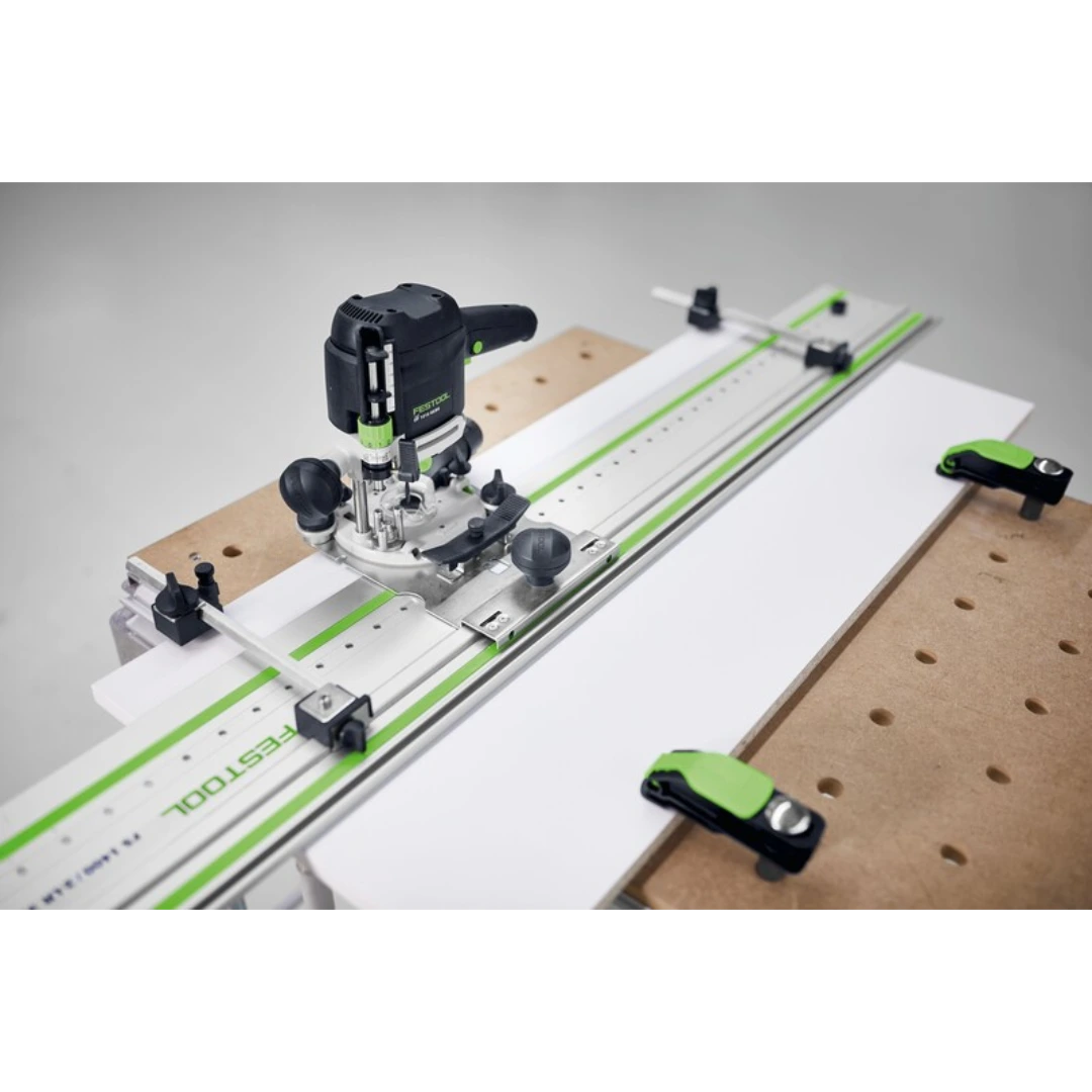 Festool hole drilling guide mounted on wood panel with clamps for precise woodworking tool accessory use