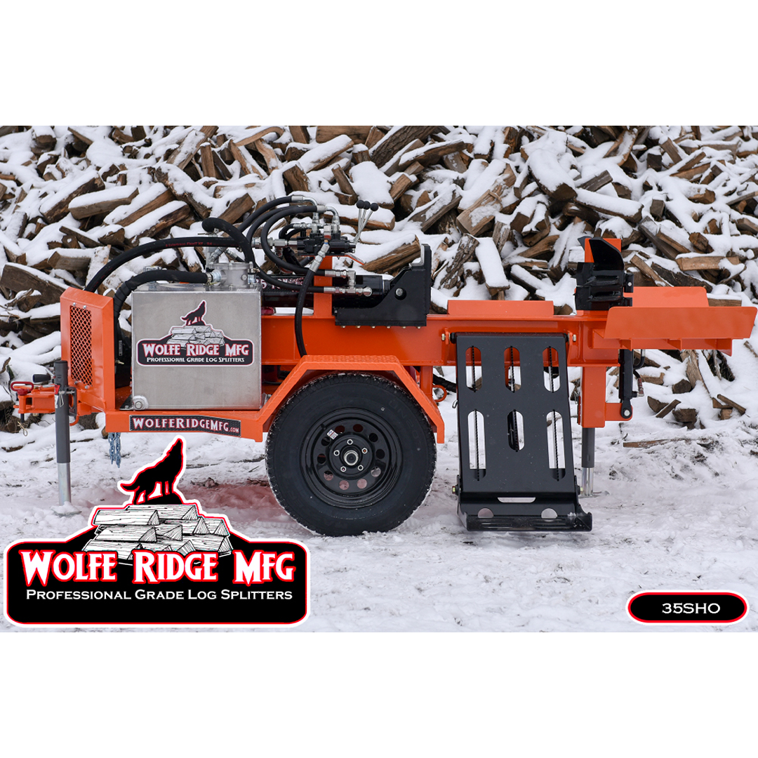 Orange Wolfe Ridge hydraulic log splitter with steel frame and wheel on snow-covered ground by stacked firewood