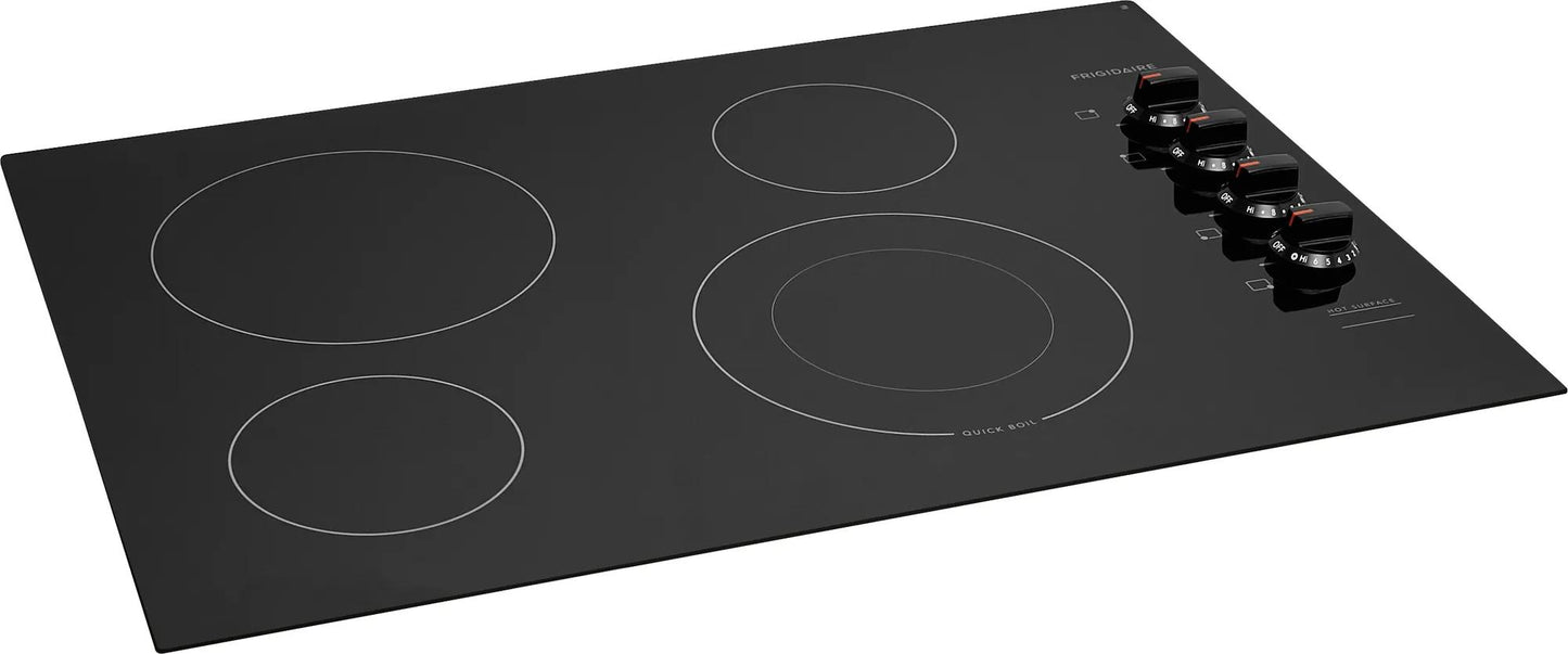 Frigidaire black frameless electric cooktop with four varied-size heating elements and rotary controls in kitchen appliance collection