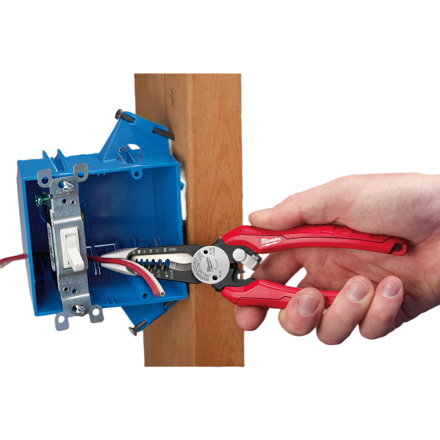 Hand using red comfort grip combination pliers to strip wires inside blue electrical box mounted on wood for home improvement