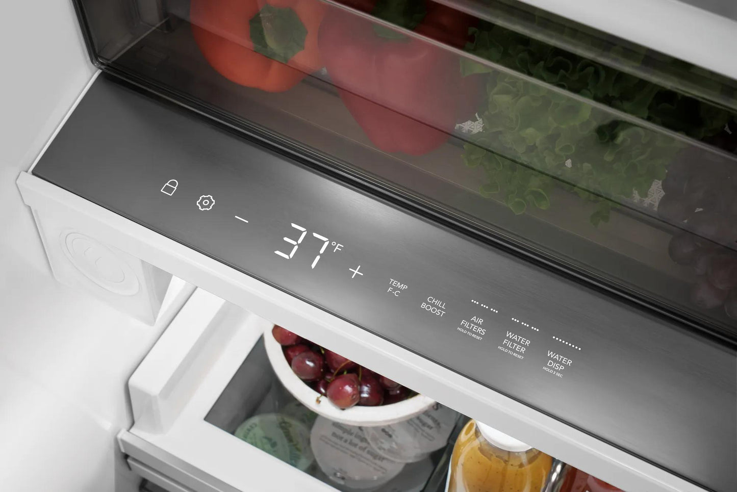 Close-up of digital temperature display and control panel inside stainless steel single-door refrigerator in kitchen setting