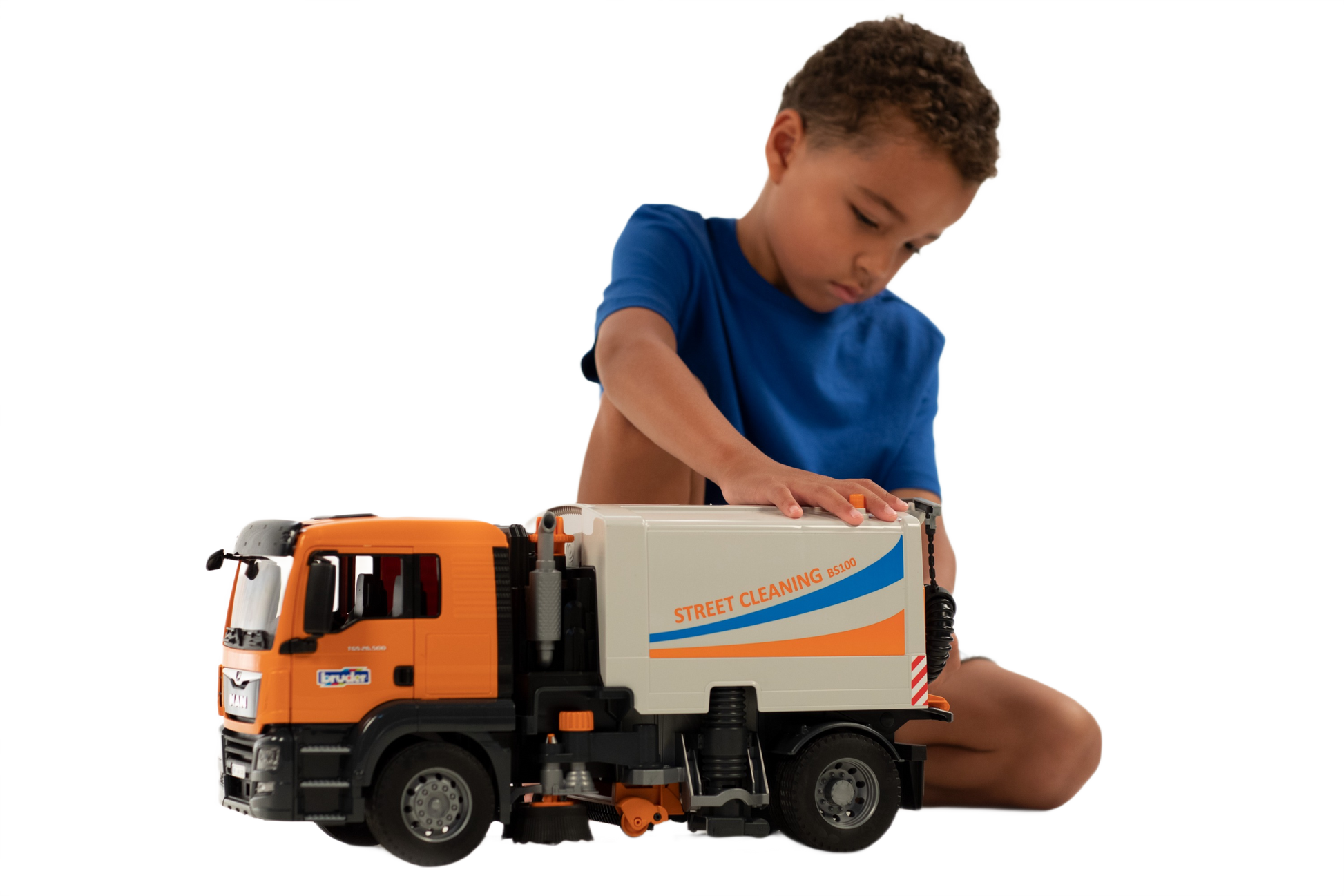Child playing with detailed orange and white MAN TGS street sweeper toy in Bruder Toys and Vehicles collections