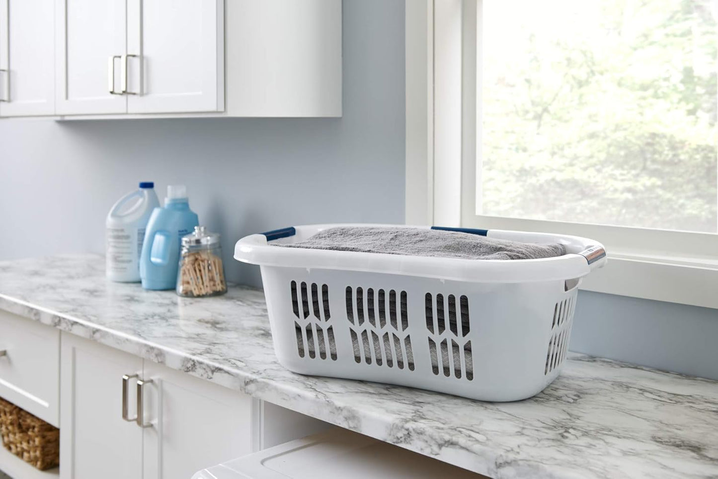 White plastic laundry basket with three sturdy handles and ventilation slots for laundry and household storage organization