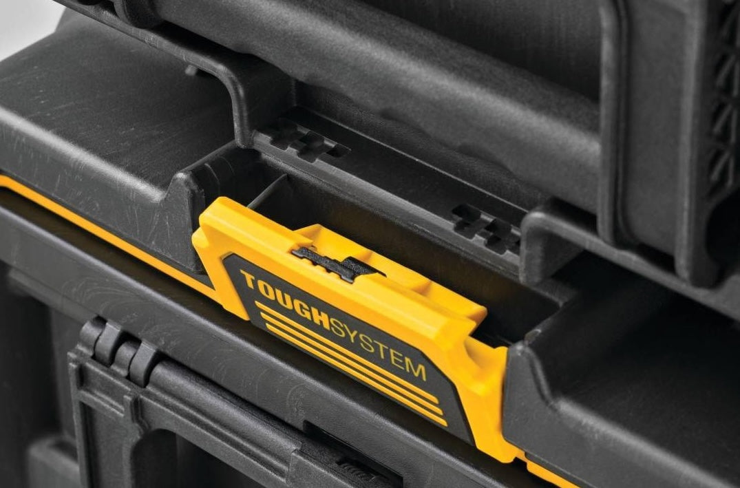 Close-up of yellow ToughSystem latch locking mechanism on a black toolbox for secure tool storage and organization