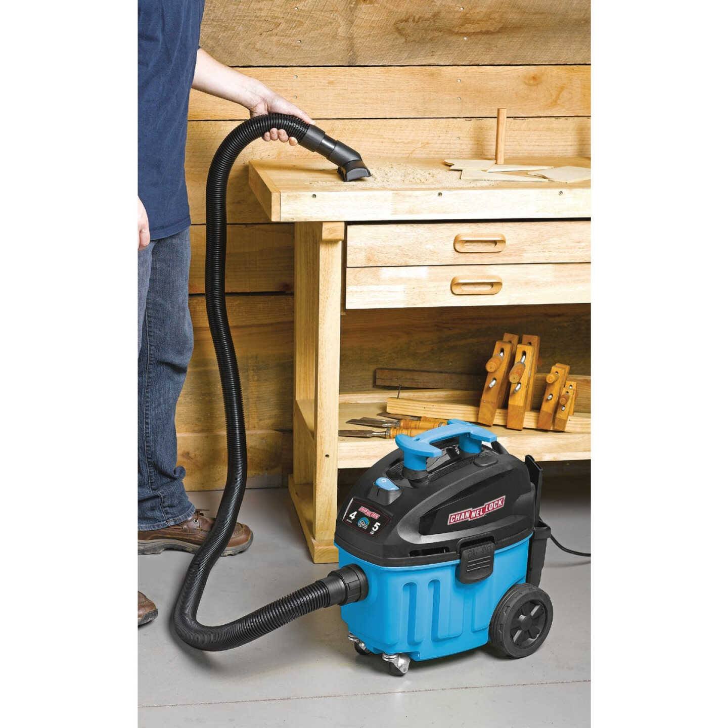 Blue and black 4-gallon contractor wet/dry vacuum with hose attached for cleaning dust and debris in home improvement tasks