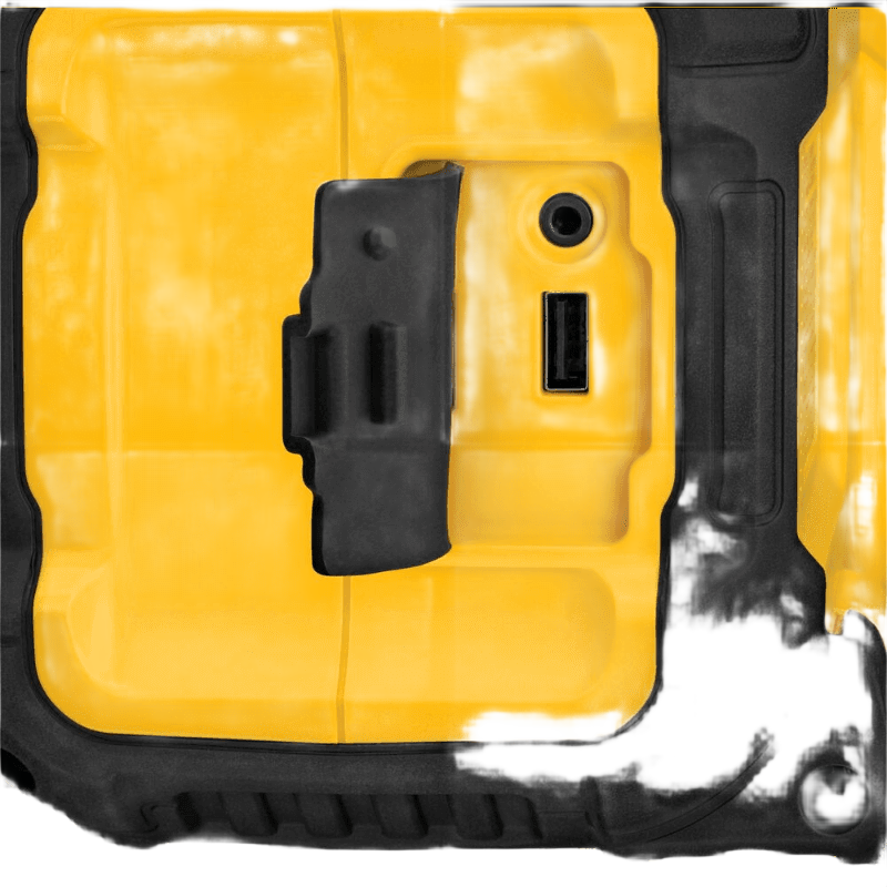 Close-up of yellow and black jobsite speaker showing USB and auxiliary input ports with protective rubber cover for tools use