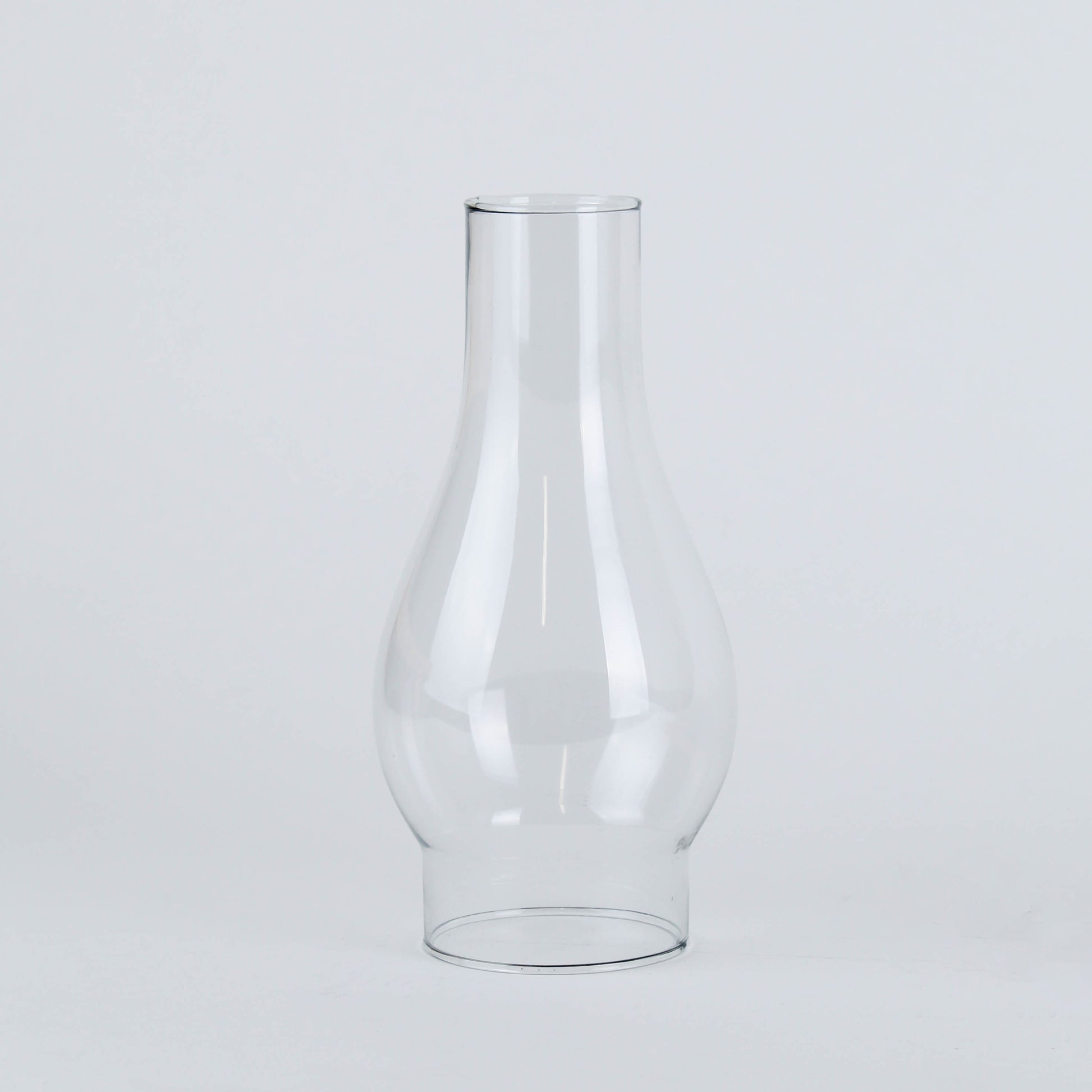 Clear glass lamp chimney with curved shape designed for flame protection and enhanced light diffusion in home improvement projects