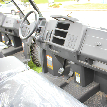 Interior view of John Deere utility vehicle with rugged dashboard and durable floor mats for outdoor and home improvement use