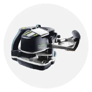 Compact handheld edge banding tool in black and gray with green accents, designed for precise application in woodworking and home improvement tasks.
