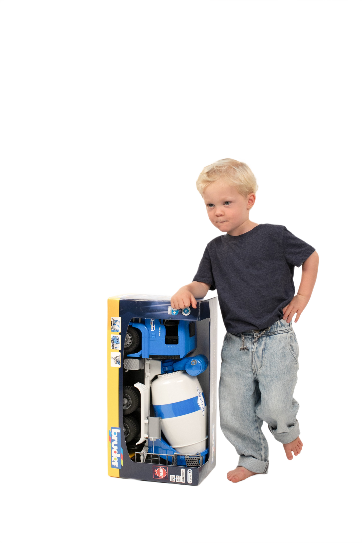 Young child standing next to a blue and white Bruder MAN TGA Cement Mixer toy in packaging from Toys & Games collection