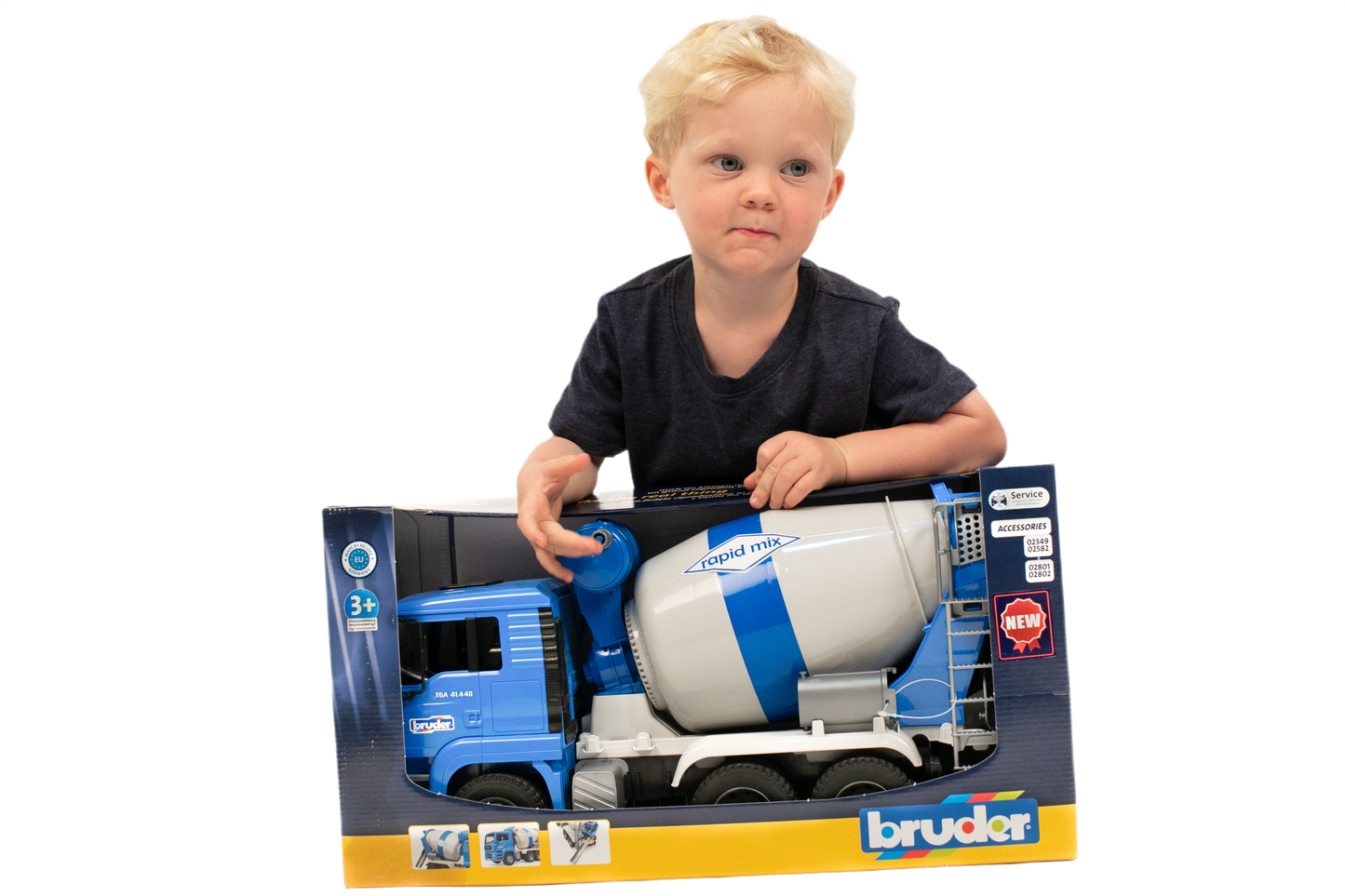 Young child playing with a blue and white Bruder MAN TGA Cement Mixer construction toy from Vehicles & Remote Controlled Toys