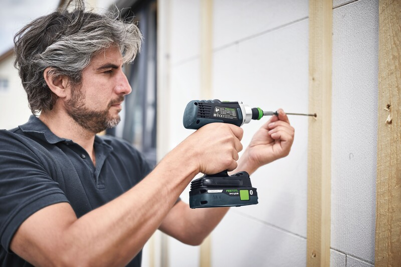 Man using a compact cordless drill with a precision bit driving a screw into an exterior wall in Home Improvement Tools collections