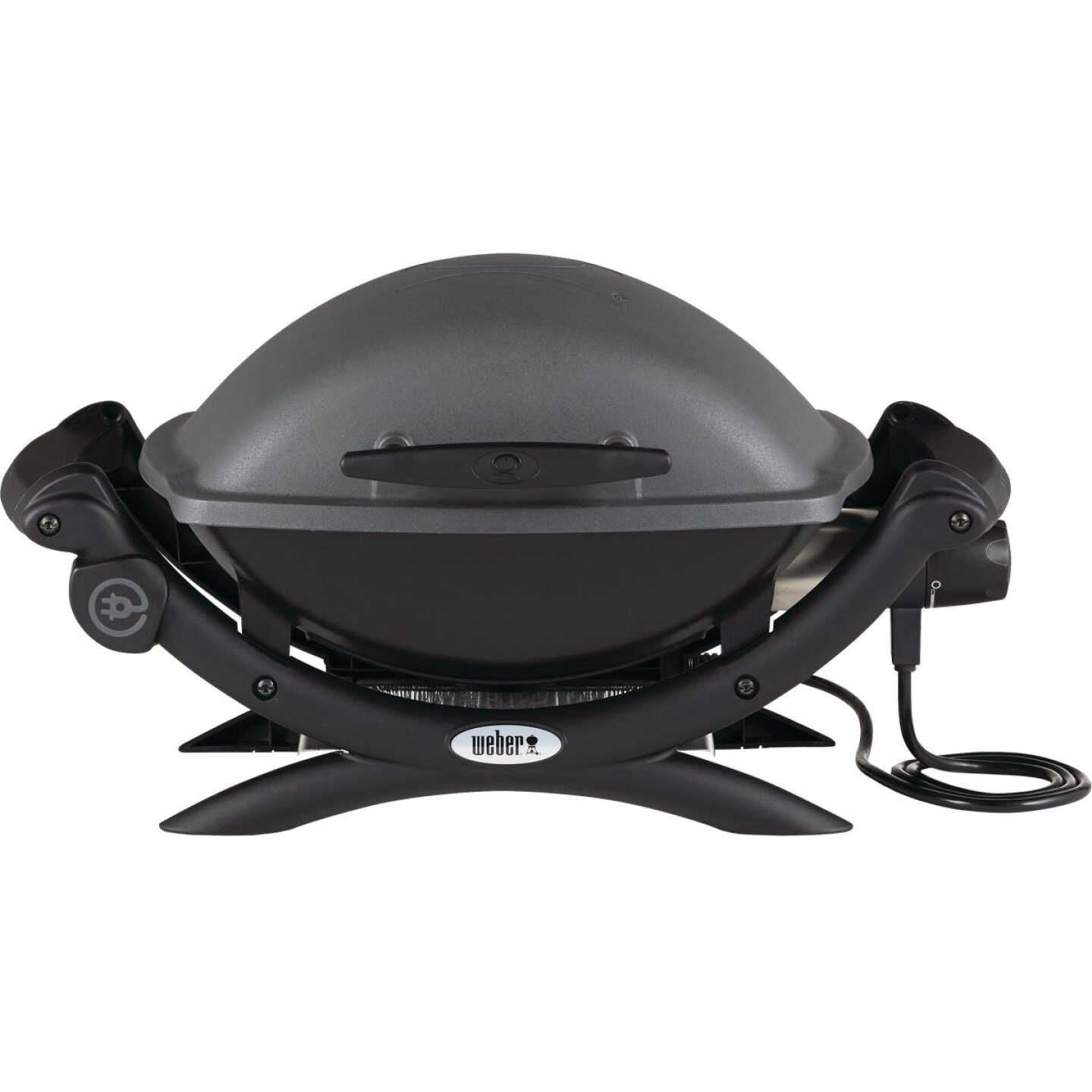 Compact gray electric grill with curved lid, sturdy frame, and power cord for portable outdoor grilling use