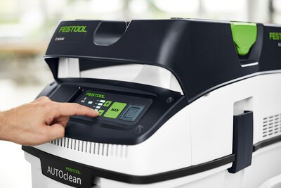 Close-up of hand pressing control buttons on Festool CT 26 EI HEPA dust extractor for woodworking tools and air filtration