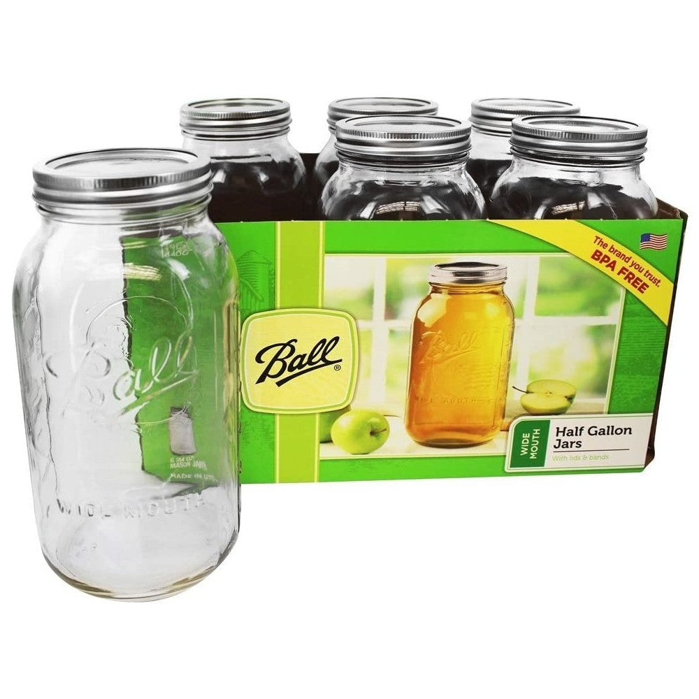 Six half-gallon clear wide mouth glass jars with metal lids for preserving and home storage tasks