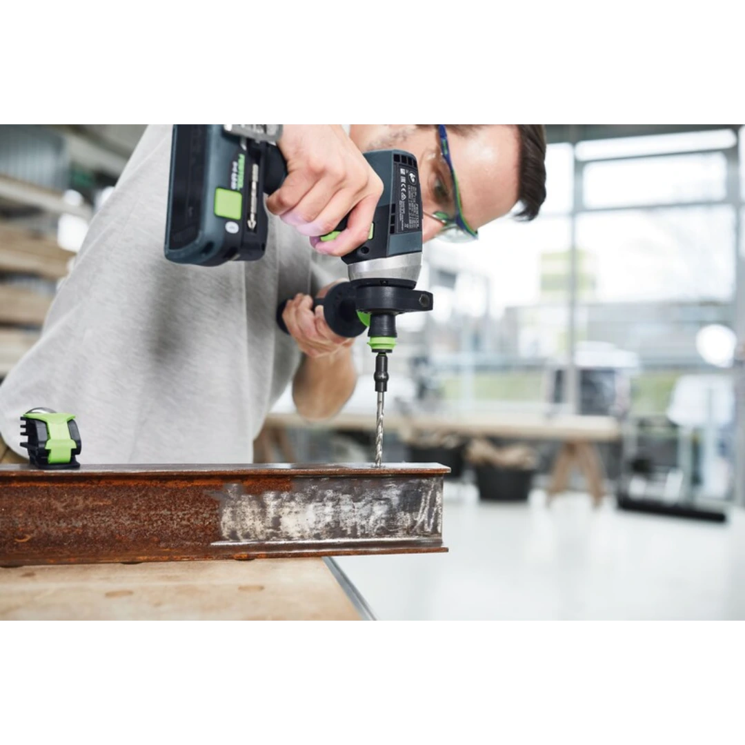 Person using a cordless drill with Centrotec spiral bit to drill a hole in rusty metal for home improvement tools collection