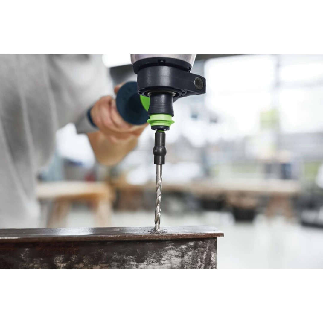 Drill with compact Centrotec spiral bit creating precise hole in metal for power tool accessories and home improvement tasks