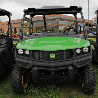 Green utility vehicle front view with rugged tires and reinforced bumper for heavy-duty outdoor tasks and home improvement use