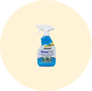 Spray bottle of Aussie Rain NeverWet water-repellent solution with blue liquid inside and a trigger nozzle, designed for outdoor protection.